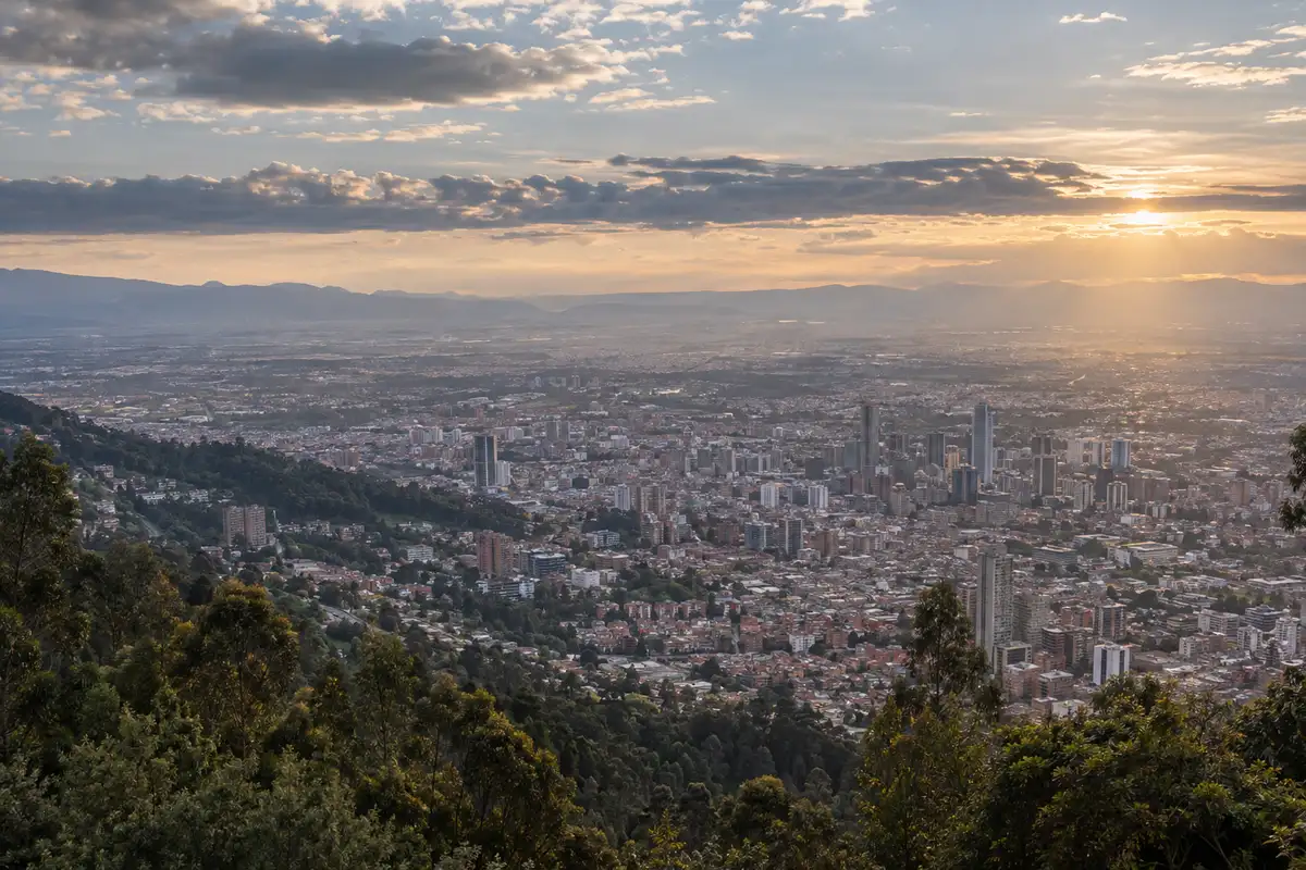 Illustration of Bogotá across the Andean plateau in late afternoon light